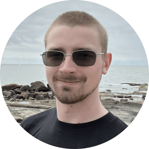 Alan J. Cutshall beach selfie wearing sunglasses and black shirt